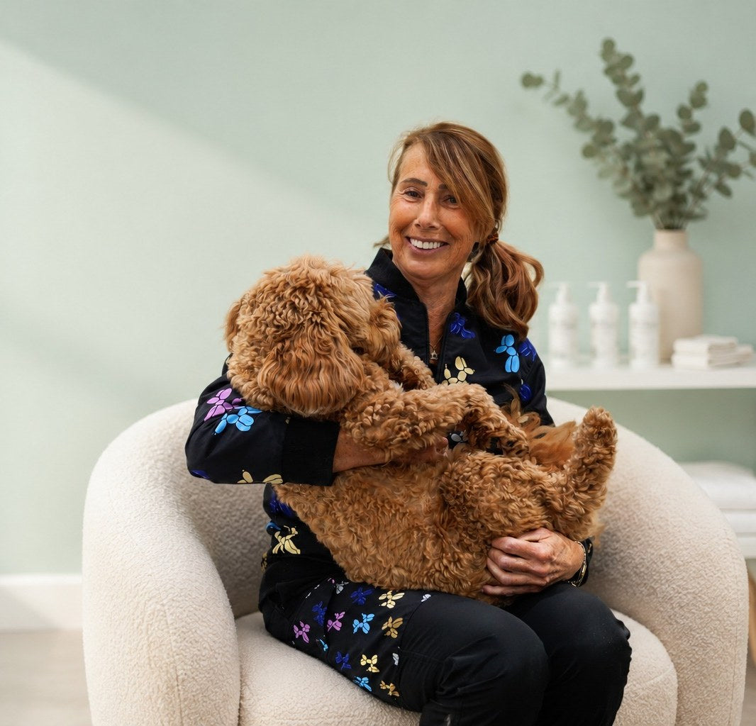 Janet, founder of WOW Grooming, holding a freshly groomed doodle